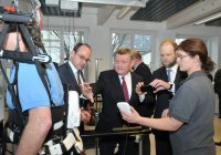 Prof. Dr. Thomas A. Schildhauer (links) erläutert Bundesgesundheitsminister Hermann Gröhe (Mitte) die Bewegungstherapie mit dem Roboteranzug HAL - Bild: Volker Daum/Bergmannsheil